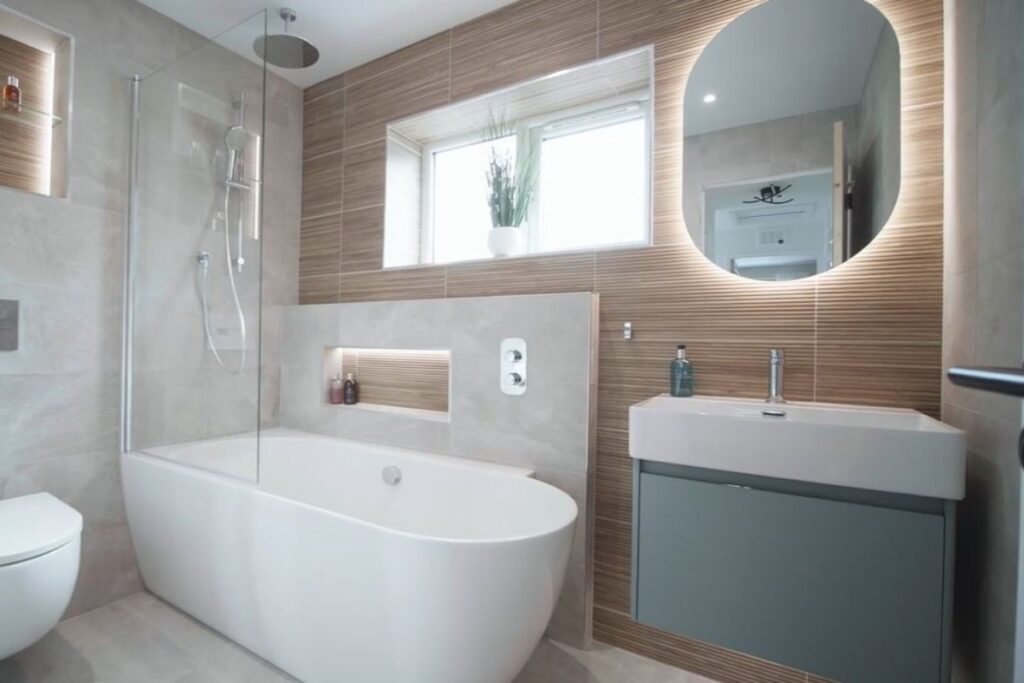 A serene bathroom featuring a large white soaking tub, wood-slat accent walls, a glass shower panel, and soft ambient lighting.